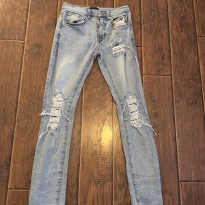 Big rip on both knees one rip on upper left thigh